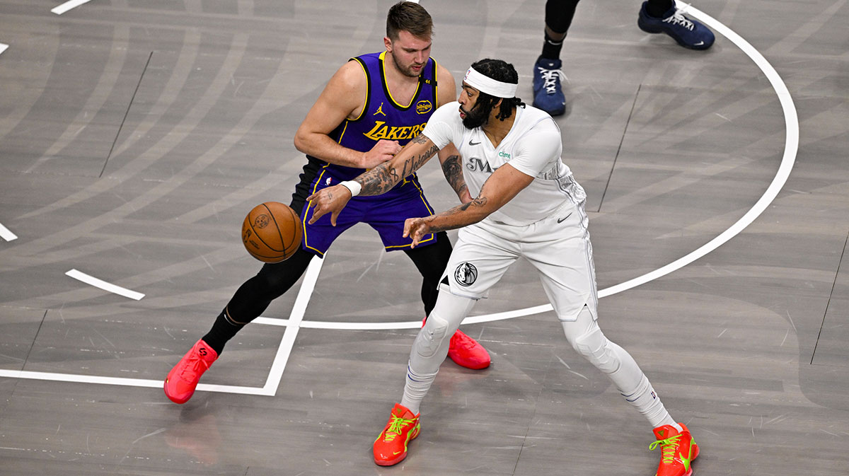 Dallas Mavericks forward Anthony Davis (3) looks to pass the ball by Los Angeles Lakers guard Luka Doncic (77) during the first quarter at the American Airlines Center.