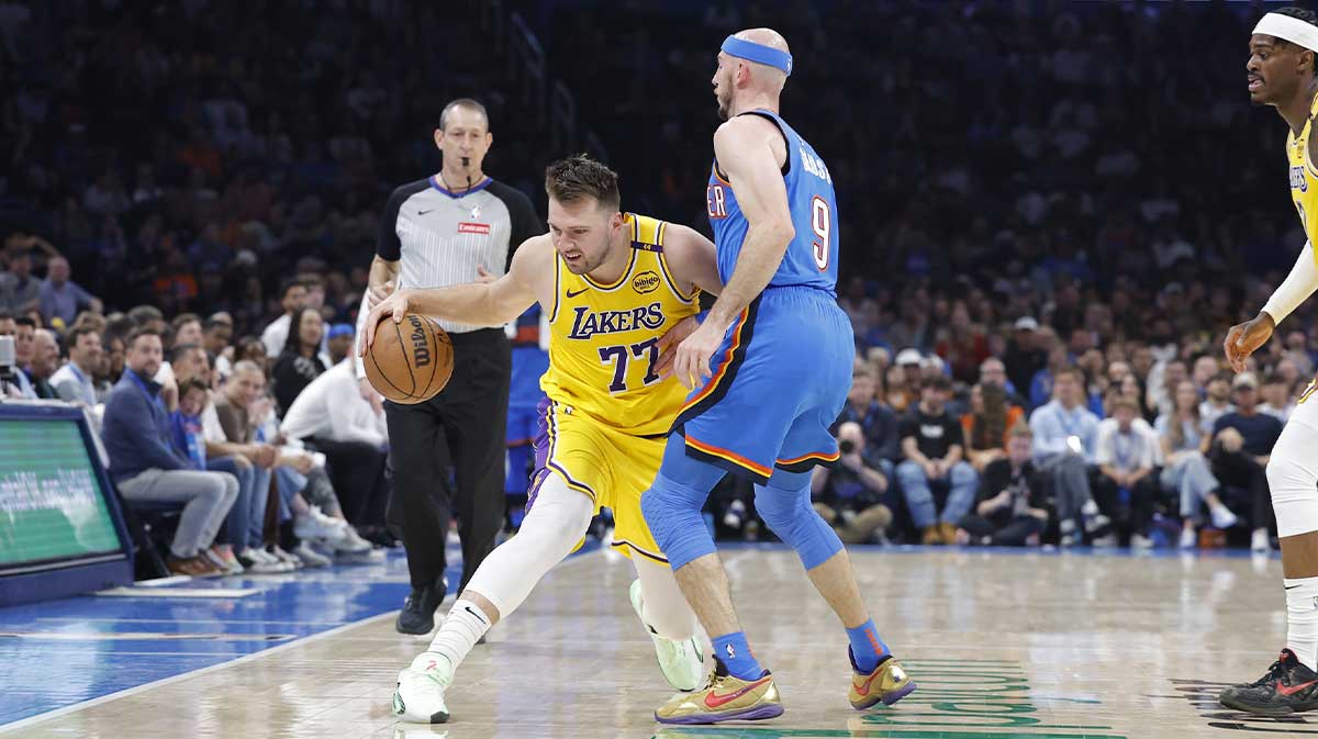 Oklahoma City, Oklahoma, USA; Los Angeles Lakers guard Luka Doncic (77) moves the ball down the court against Oklahoma City Thunder guard Alex Caruso (9) during the second quarter at Paycom Center.
