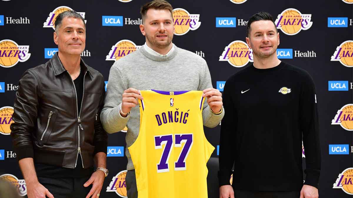 Los Angeles Lakers guard Luka Doncic poses for photos with general manager Rob Pelinka and head coach JJ Redick at UCLA Health Training Center.