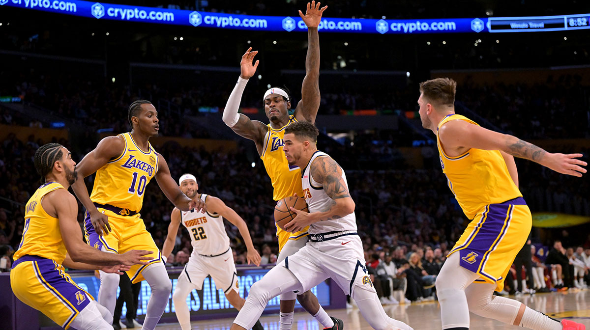 Los Angeles Lakers center Christian Koloko (10), guard Gabe Vincent (7), forward Jarred Vanderbilt (2) and guard Luka Doncic (77) defend a drive by Denver Nuggets forward Michael Porter Jr. (1) in the second half at Crypto.com Arena.
