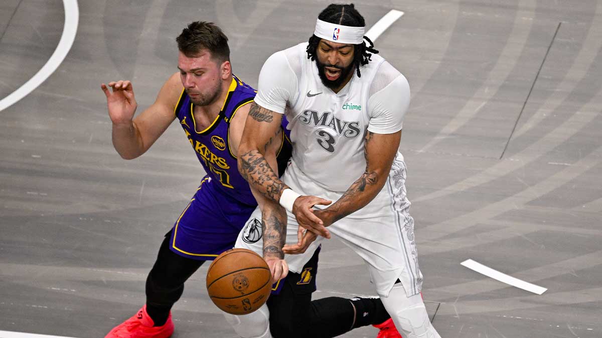 Lakers guard Luka Doncic (77) knocks the ball away from Dallas Mavericks forward Anthony Davis (3)