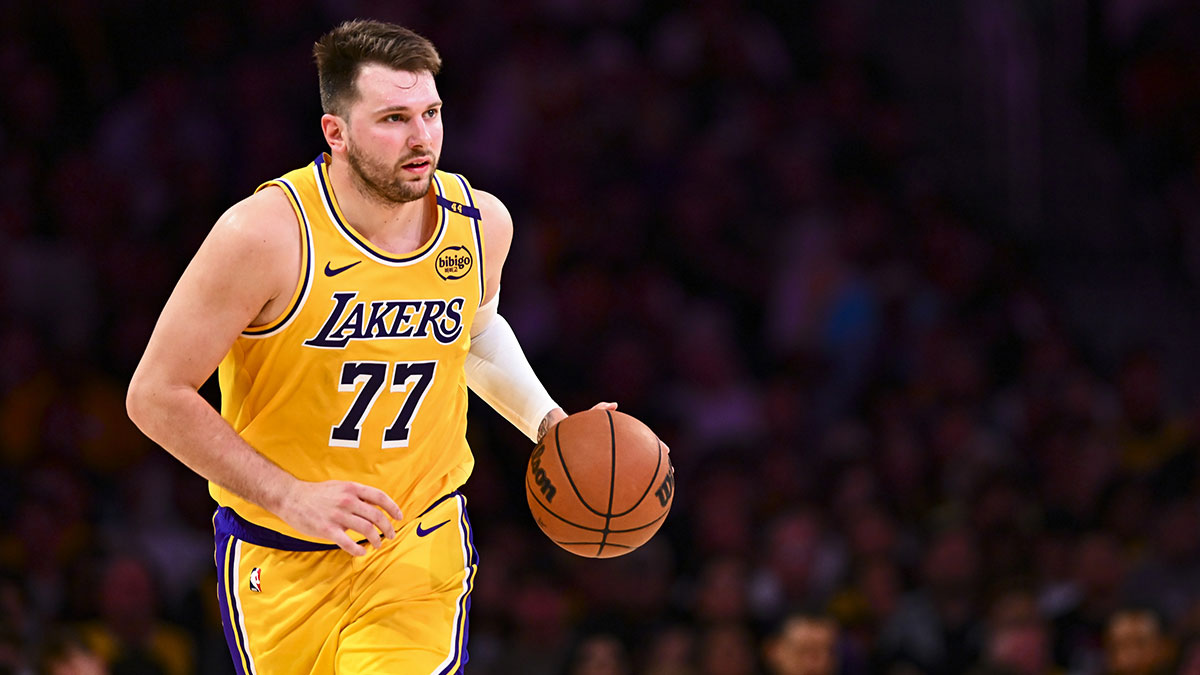Lakers guard Luka Doncic next to the Lakers logo and Anthony Davis in the background