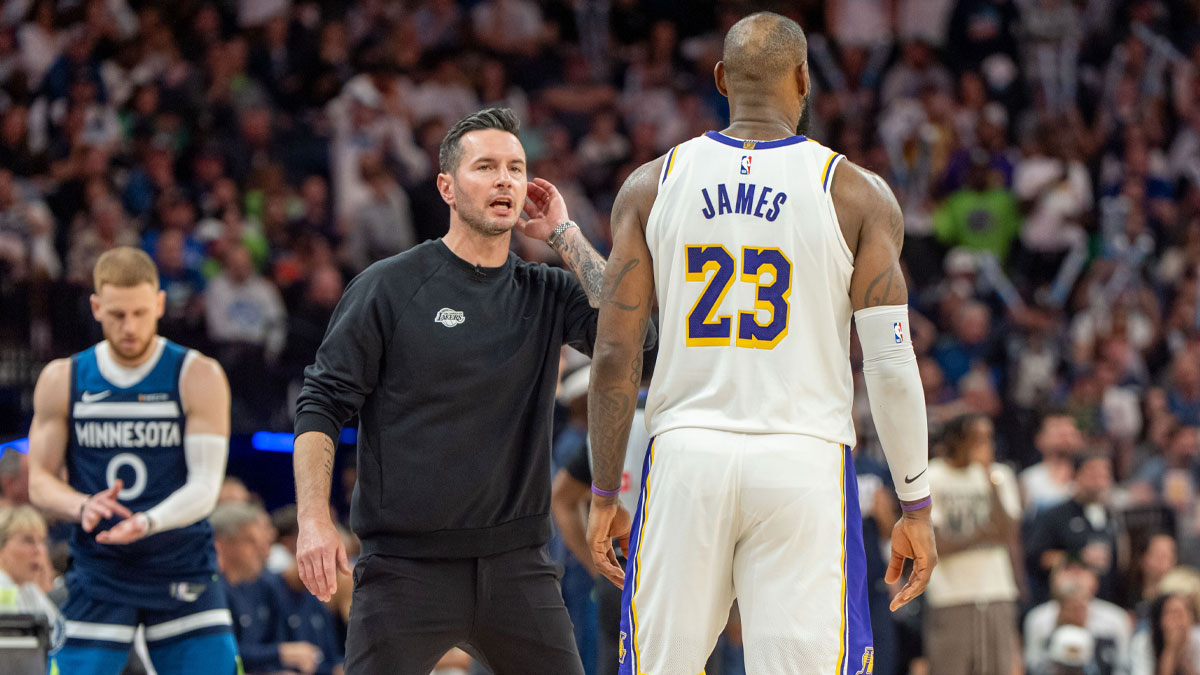 Lakers head coach JJ Redick talks with forward LeBron James (23)
