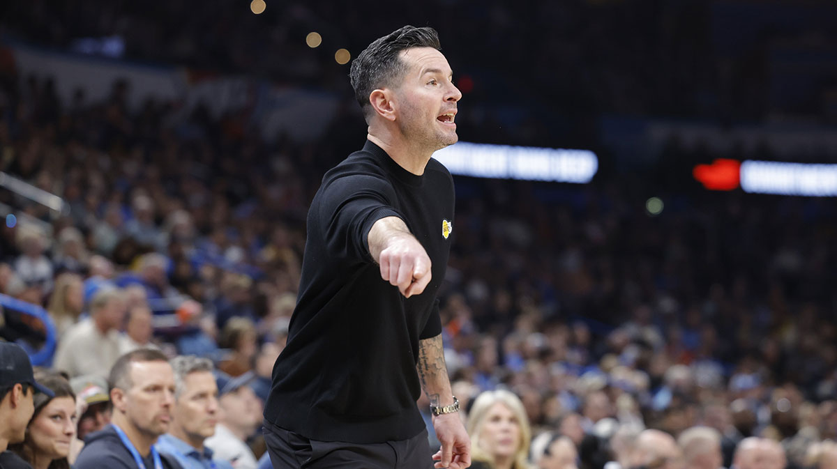 Lakers head coach JJ Redick in between Thunder All-Star Jalen Williams and Thunder's Chet Holmgren