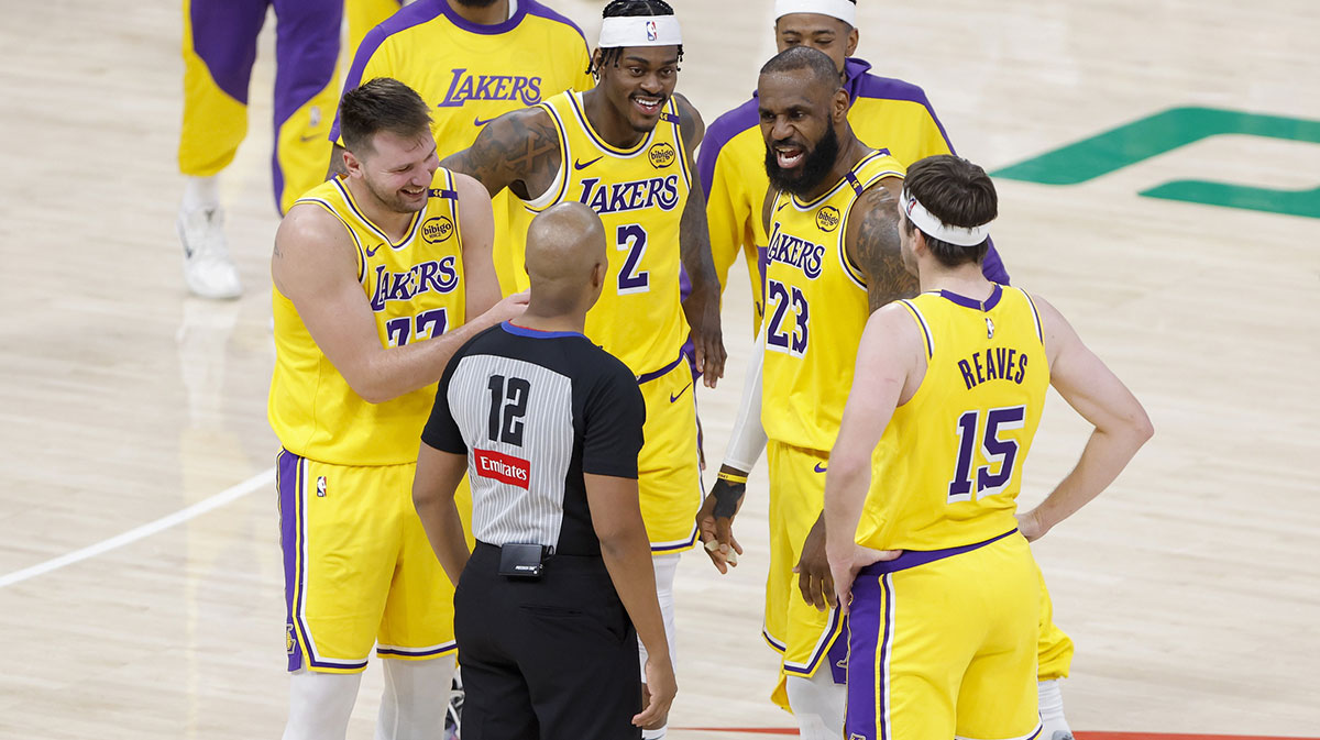 Lakers team with the Lakers logo and Paul Pierce in the background next to the Warriors logo