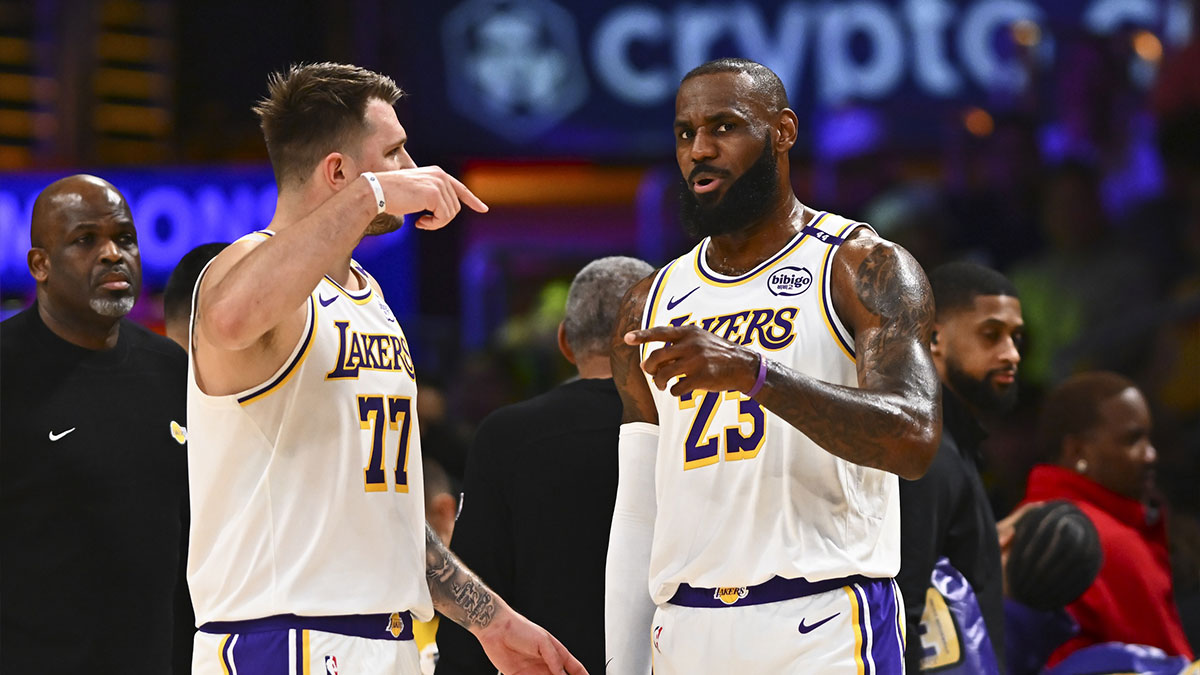 Los Angeles Lakers guard Luka Doncic (77) and Los Angeles Lakers forward LeBron James (23) on the sidelines against the Chicago Bulls during the first half at Crypto.com Arena.