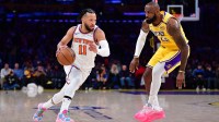New York Knicks guard Jalen Brunson (11) moves the ball against Los Angeles Lakers forward LeBron James (23) during the first half at Crypto.com Arena.