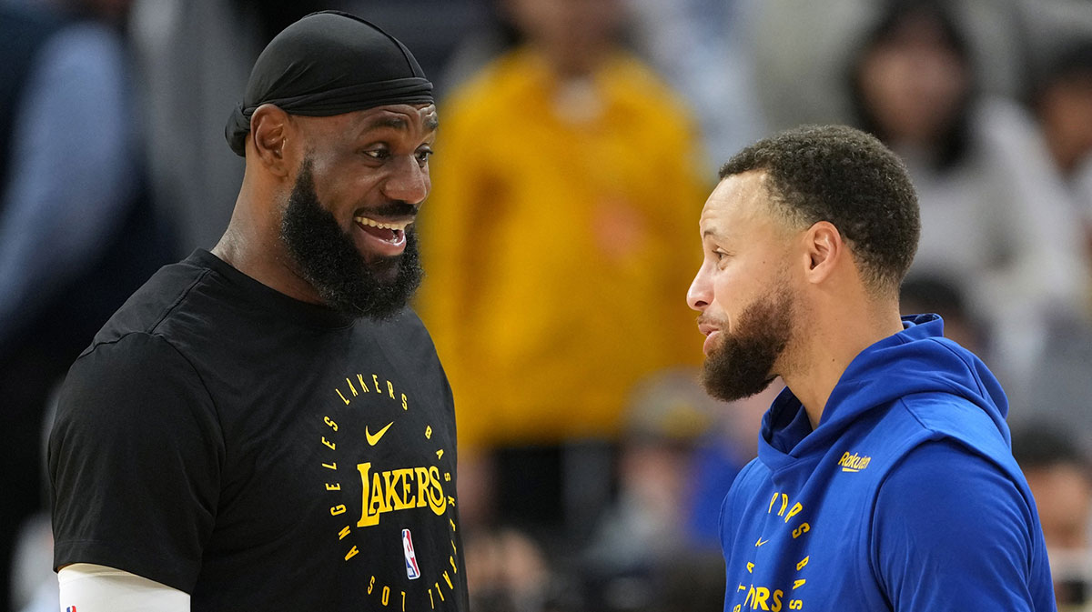 Los Angeles Lakers forward LeBron James (left) and Golden State Warriors guard Stephen Curry (right) talk before the game at Chase Center.