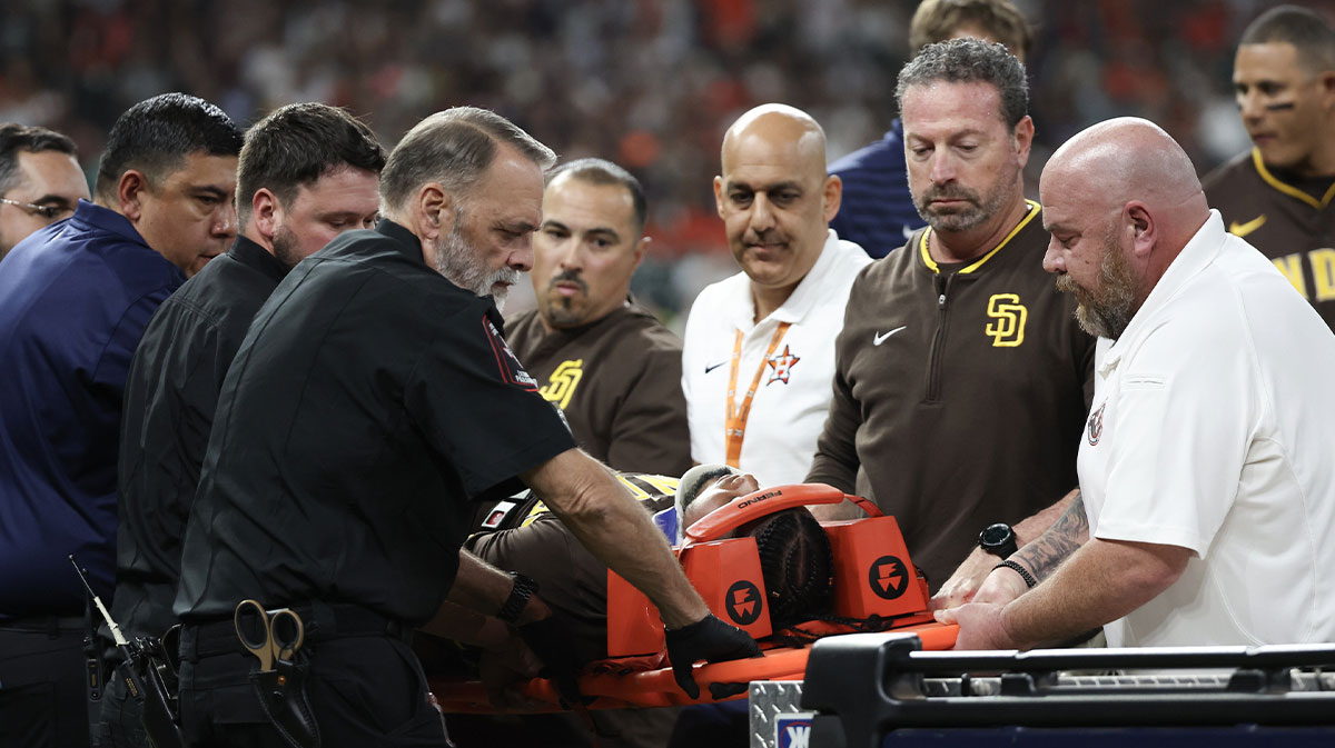 San Diego Padres designated hitter Luis Arraez (4) is carted off the field after he colliding with Houston Astros first baseman Christian Walker (8) (not pictured )on the first base line in the first inning at Daikin Park.