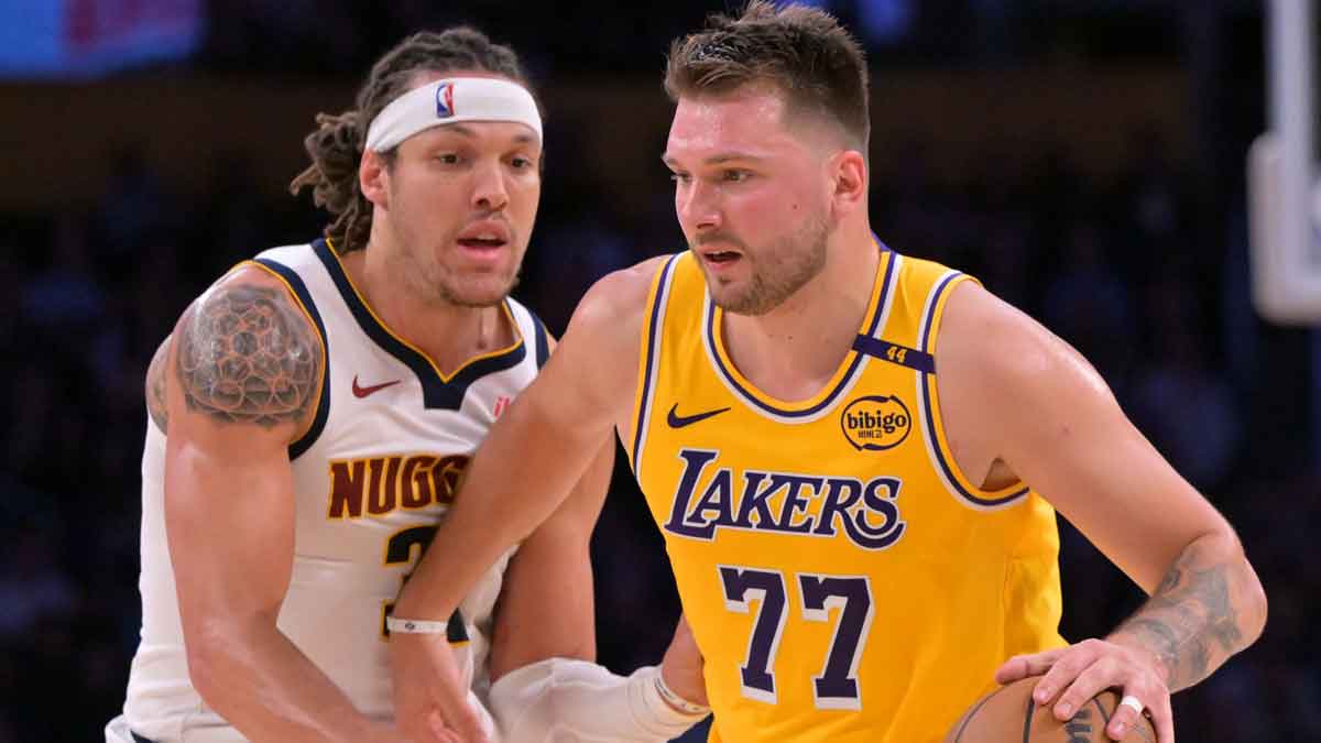 Los Angeles Lakers guard Luka Doncic (77) is guarded by Denver Nuggets forward Aaron Gordon (32) in the first half at Crypto.com Arena.