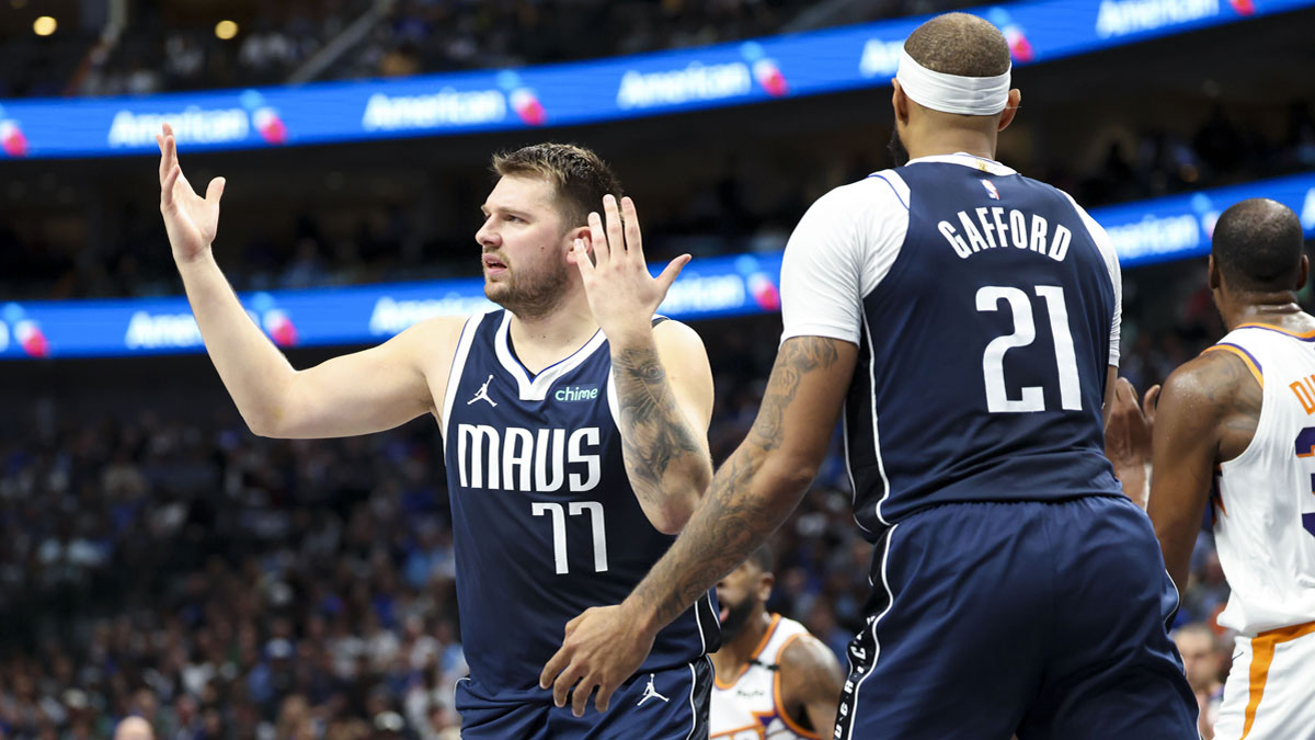 Dallas Mavericks guard Luka Doncic (77) reacts in front of Dallas Mavericks center Daniel Gafford (21) during the first quarter against the Phoenix Suns at American Airlines Center.
