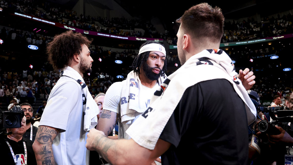 Los Angeles Lakers guard Luka Doncic (77) hugs Dallas Mavericks forward Anthony Davis (3) after the game at American Airlines Center.