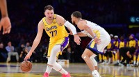 Los Angeles Lakers guard Luka Doncic (77) moves the ball against Golden State Warriors guard Stephen Curry (30) during the first half at Crypto.com Arena.