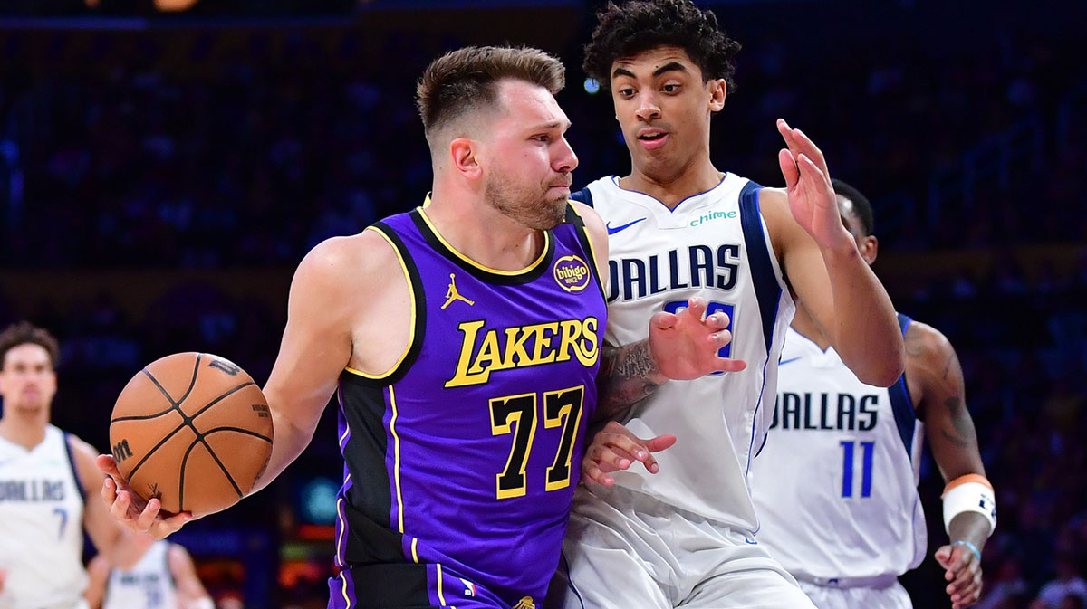 Los Angeles Lakers guard Luka Doncic (77) dribbles the ball Dallas Mavericks guard Max Christie (00) during the second half at Crypto.com Arena.