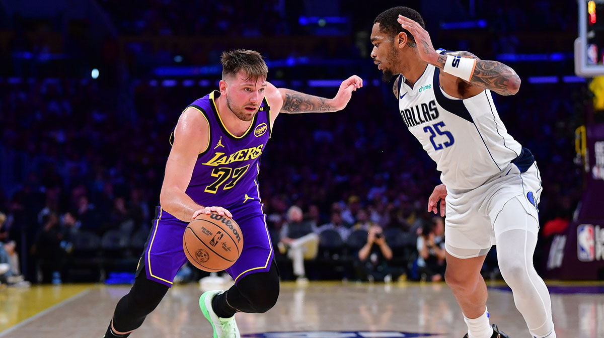 Los Angeles Lakers guard Luka Doncic (77) dribbles the ball against Dallas Mavericks forward P.J. Washington (25) during the second half at Crypto.com Arena