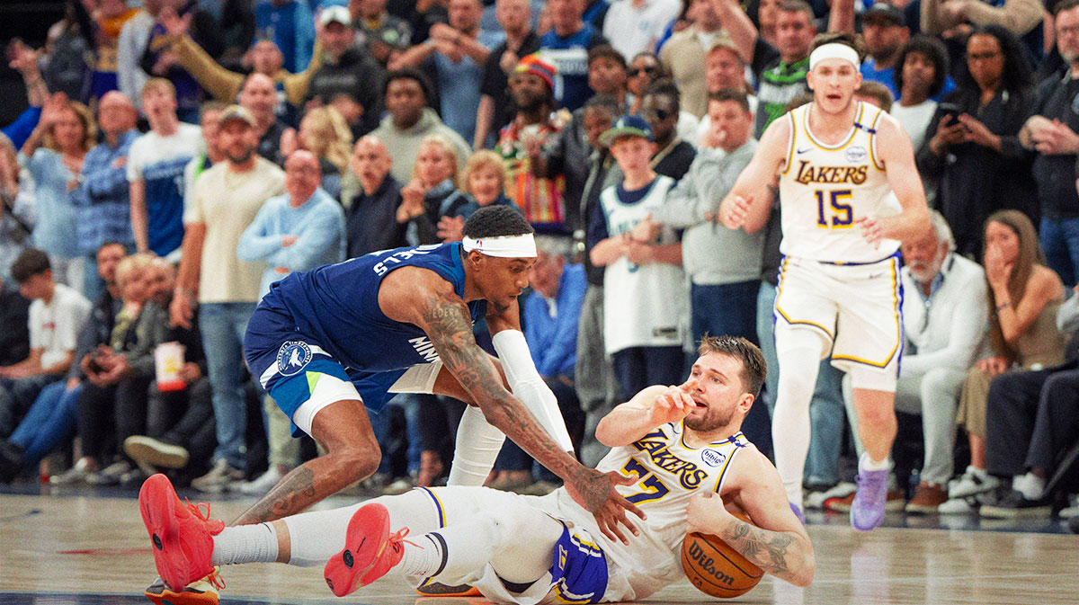 Los Angeles Lakers guard Luka Doncic (77) calls a timeout after stumbling on the defense of Minnesota Timberwolves forward Jaden McDaniels (3) in the fourth quarter during game four of first round for the 2025 NBA Playoffs at Target Center.