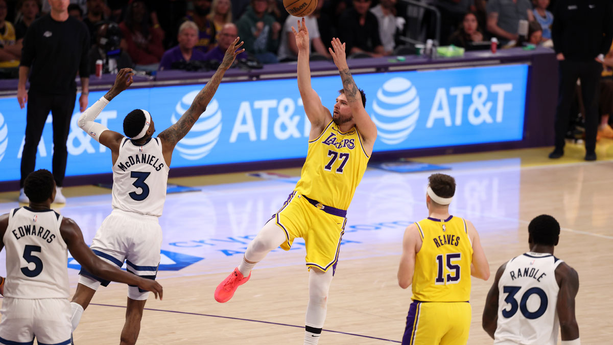 Los Angeles Lakers guard Luka Doncic (77) shoots the ball over Minnesota Timberwolves forward Jaden McDaniels (3) during the third quarter of game two of first round for the 2024 NBA Playoffs at Crypto.com Arena.