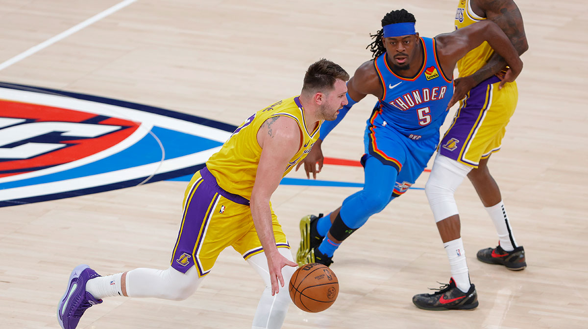 Los Angeles Lakers guard Luka Doncic (77) dribbles down the court against the Oklahoma City Thunder during the second half at Paycom Center.