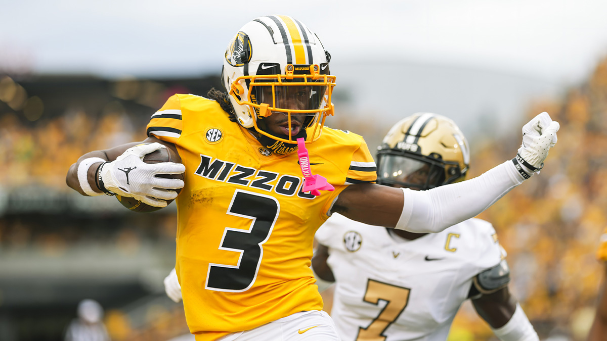Missouri Tigers wide receiver Luther Burden III (3) scores a touchdown against Vanderbilt Commodores safety Marlen Sewell (7) during the first half at Faurot Field at Memorial Stadium.