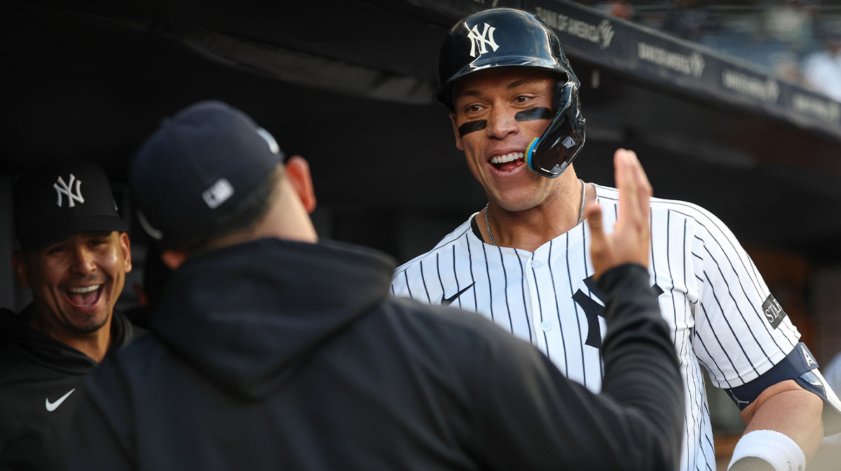 New York Yankees right fielder Aaron Judge (99) celebrates his solo home run during the sixth inning with teammates against the Toronto Blue Jays at Yankee Stadium.