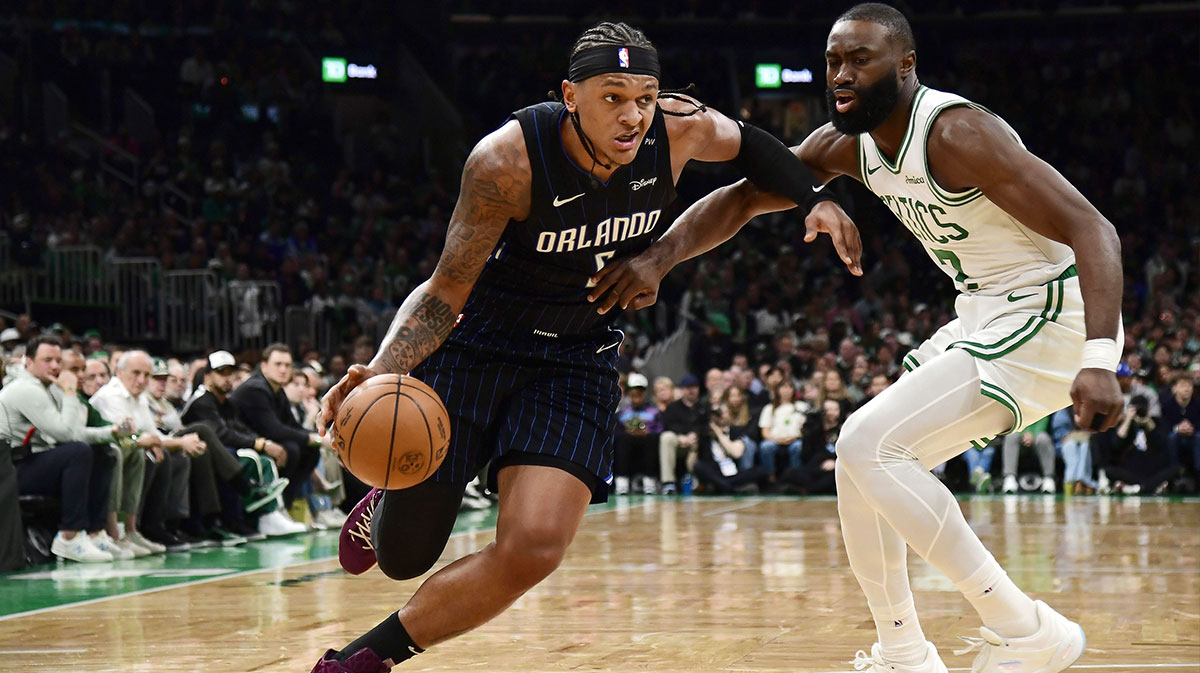 Orlando Magic forward Paolo Banchero (5) controls the ball while Boston Celtics guard Jaylen Brown (7) defends during the first half at TD Garden.