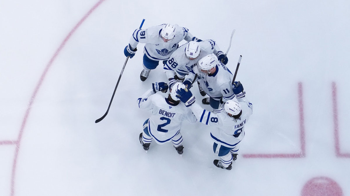 Toronto Maple Leafs right wing William Nylander (88) is congratulated after his goal by defenseman Chris Tanev (8), defenseman Simon Benoit (2), center John Tavares (91) and center Max Domi (11) against the Carolina Hurricanes during the third periodat Lenovo Center.