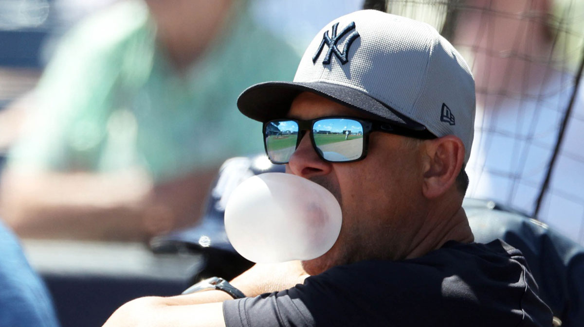 Mar 15, 2025; Port Charlotte, Florida, USA; New York Yankees manager Aaron Boone (17) blows a bubble with his gum during the second inning against the Tampa Bay Rays at Charlotte Sports Park.