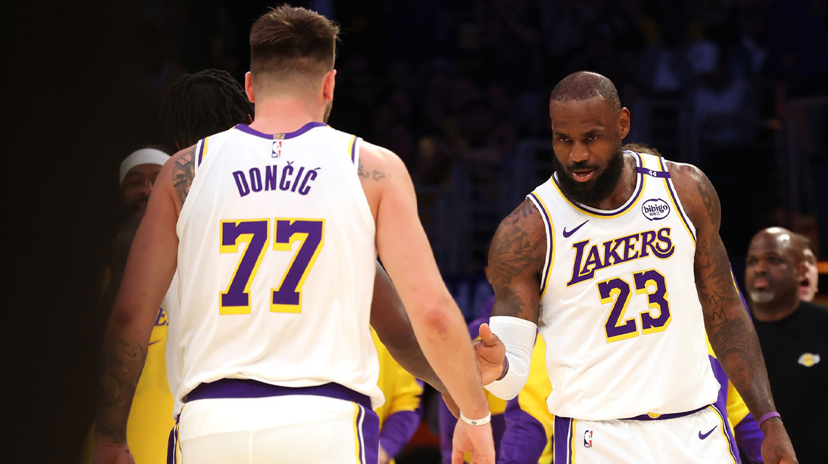 Los Angeles Lakers forward LeBron James (23) and guard Luka Doncic (77) react after a play during the first quarter against the LA Clippers at Crypto.com Arena.