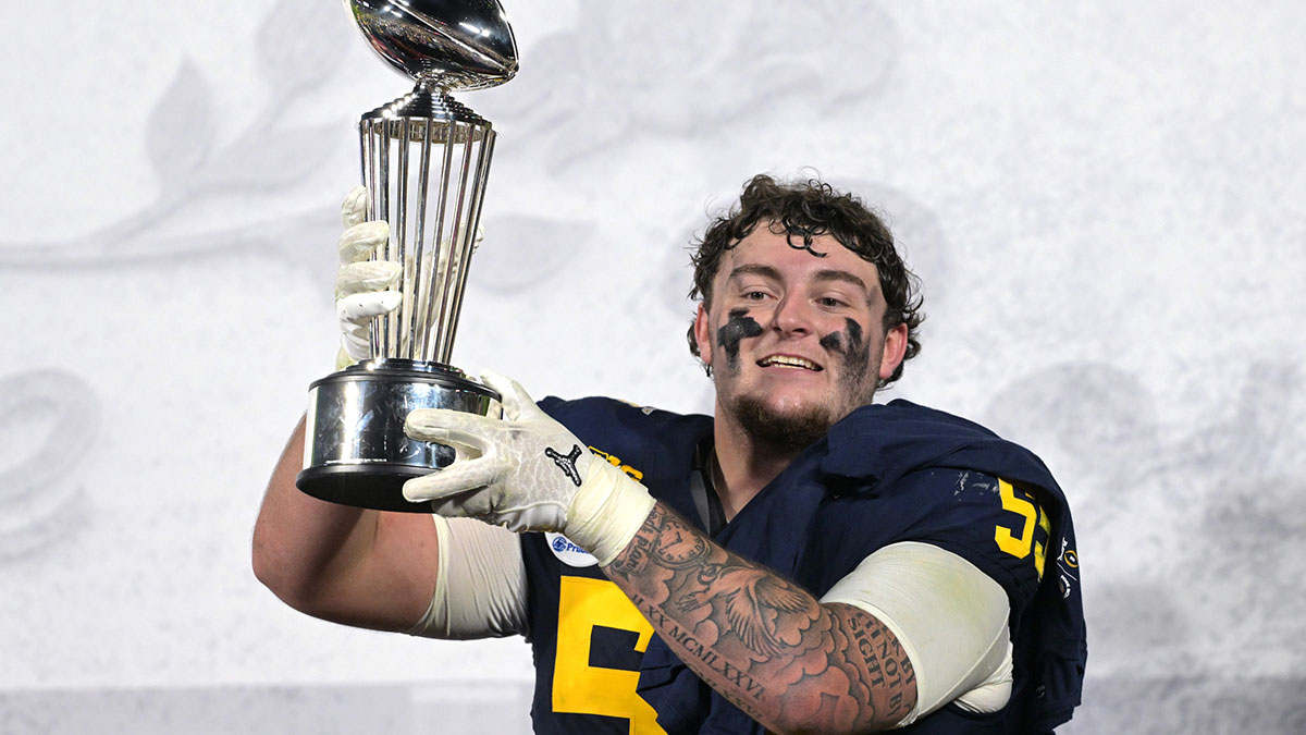 Michigan Wolverines defensive lineman Mason Graham (55) celebrates with the Leishman Trophy after defeating the Alabama Crimson Tide in the 2024 Rose Bowl college football playoff semifinal game at Rose Bowl.