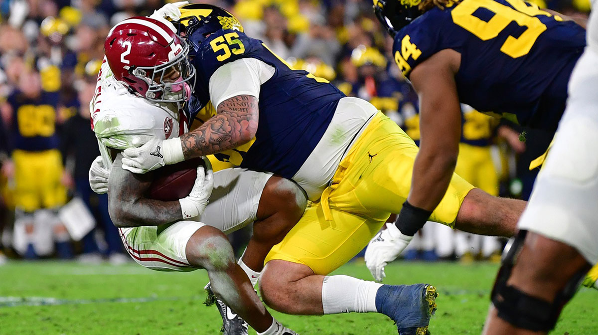 Michigan Wolverines defensive lineman Mason Graham (55) tackles Alabama Crimson Tide running back Jase McClellan (2) during overtime in the 2024 Rose Bowl college football playoff semifinal game at Rose Bowl.