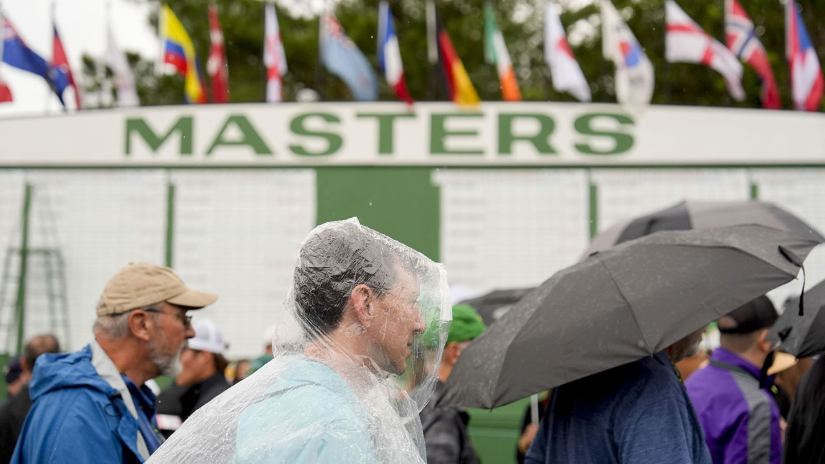 Patrons leave the course as inclement weather suspends play during a practice round of the Masters Tournament at Augusta National Golf Club
