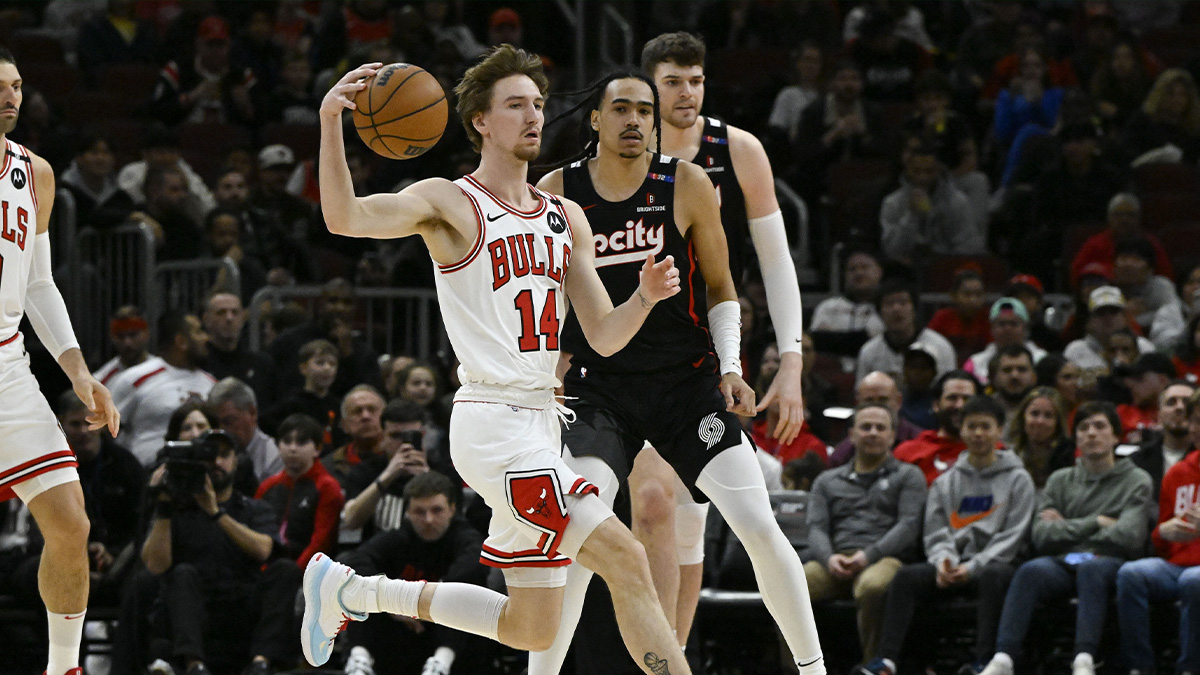Chicago Bulls forward Matas Buzelis (14) moves the ball past Portland Trail Blazers guard Dalano Banton (5) during the first half at United Center.
