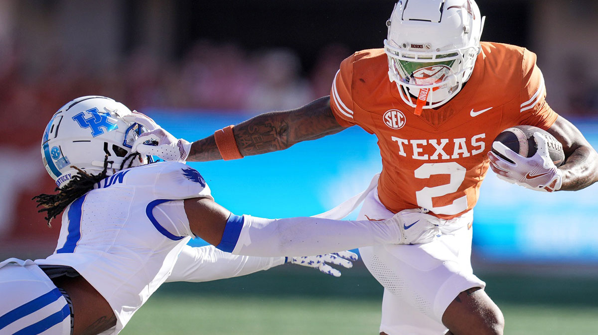 Texas Longhorns wide receiver Matthew Golden (2) stiff arms Kentucky Wildcats defensive back Maxwell Hairston (1) in the first quarter of an NCAA college football game at Darrell K Royal Texas Memorial Stadium in Austin, Texas on Saturday, Nov. 24, 2024. Packers draft Golden.