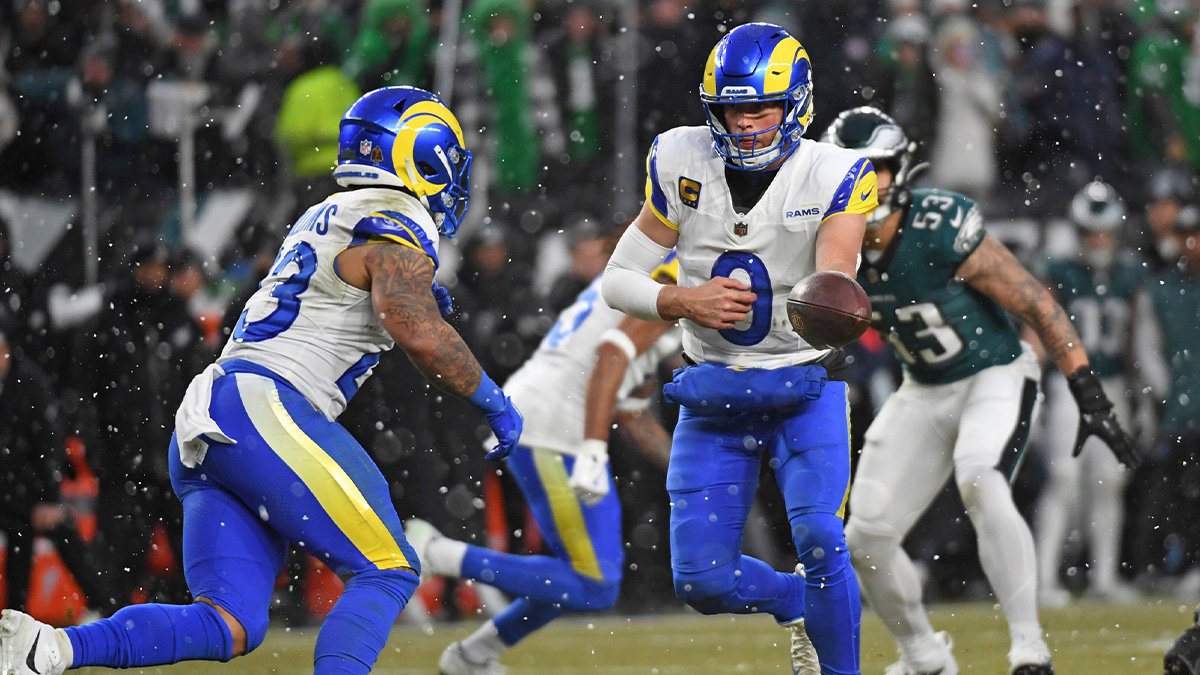 Los Angeles Rams quarterback Matthew Stafford (9) hands the ball off to running back Kyren Williams (23) against the Philadelphia Eagles in a 2025 NFC divisional round game at Lincoln Financial Field.