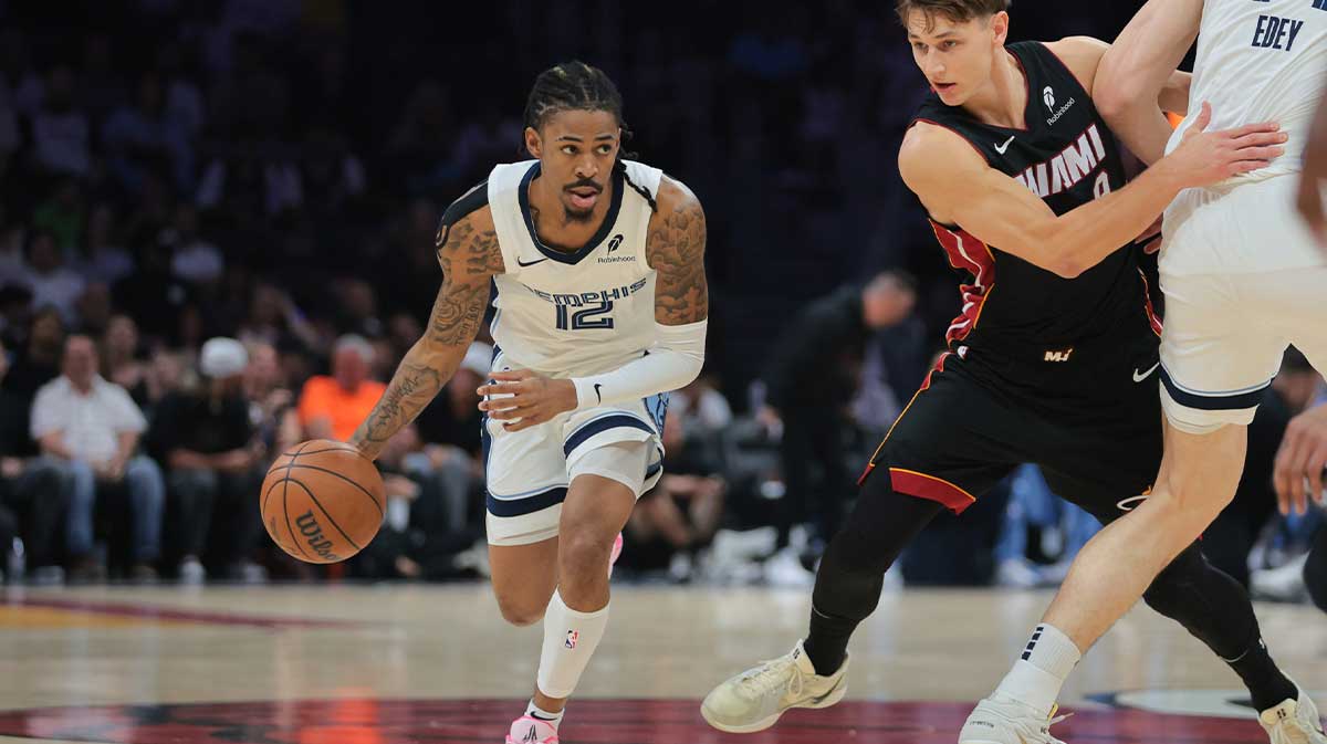 Memphis Grizzlies guard Ja Morant (12) drives to the basket past Miami Heat guard Pelle Larsson (9) during the first quarter at Kaseya Center.