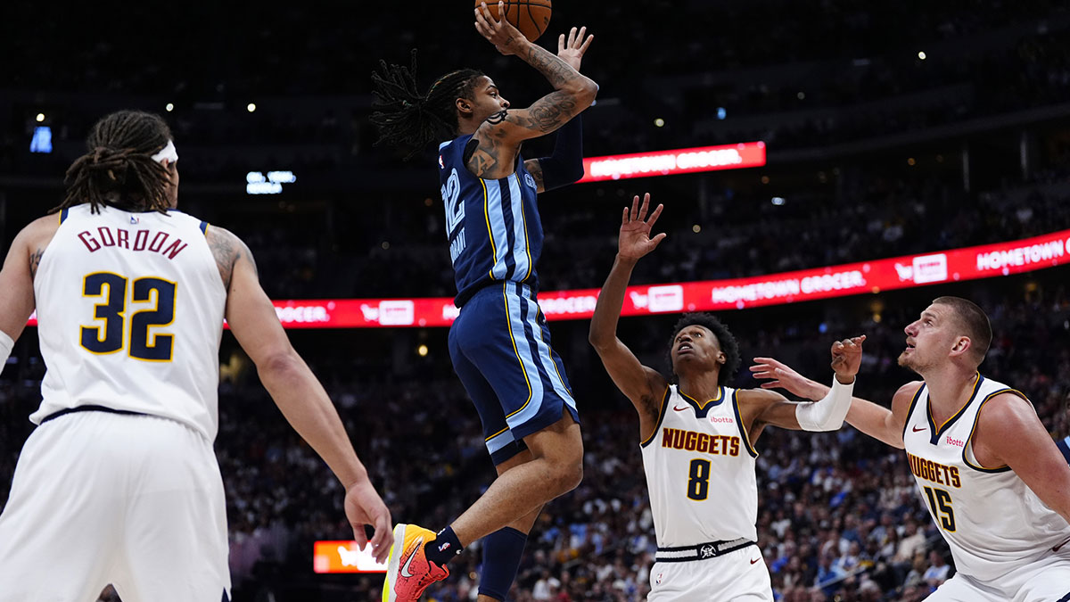 Memphis Grizzlies guard Ja Morant (12) shoots the ball over Denver Nuggets forward Peyton Watson (8) and center Nikola Jokic (15) in the second quarter at Ball Arena.
