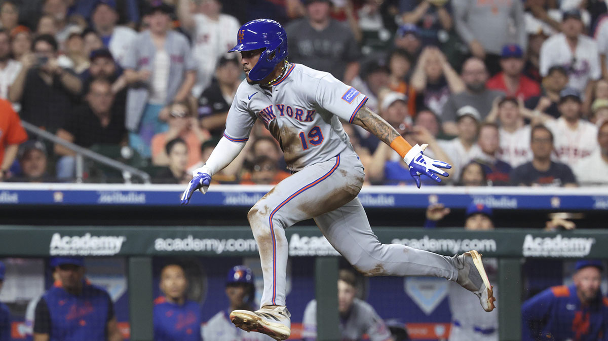 New York Mets center fielder Jose Siri (19) scores on a fielders choice during the sixth inning against the Houston Astros at Daikin Park.
