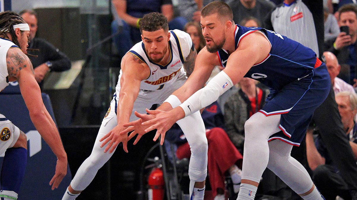 Denver Nuggets forward Michael Porter Jr. (1) and Los Angeles Clippers center Ivica Zubac (40) reach for a loose ball in the first half of game four of round one of the 2024 NBA Playoffs at Intuit Dome.
