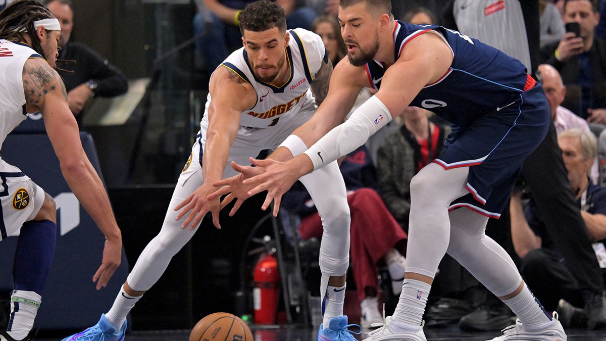 Denver Nuggets forward Michael Porter Jr. (1) and Los Angeles Clippers center Ivica Zubac (40) reach for a loose ball in the first half of game four of round one of the 2024 NBA Playoffs at Intuit Dome.