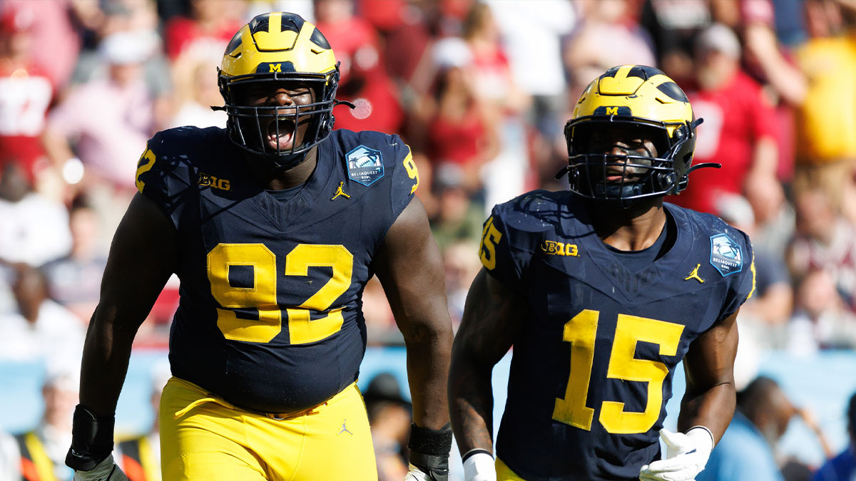 Michigan Wolverines defensive lineman Ike Iwunnah (92) celebrates a sack with Michigan Wolverines linebacker Ernest Hausmann (15) against the Alabama Crimson Tide during the second half at Raymond James Stadium.