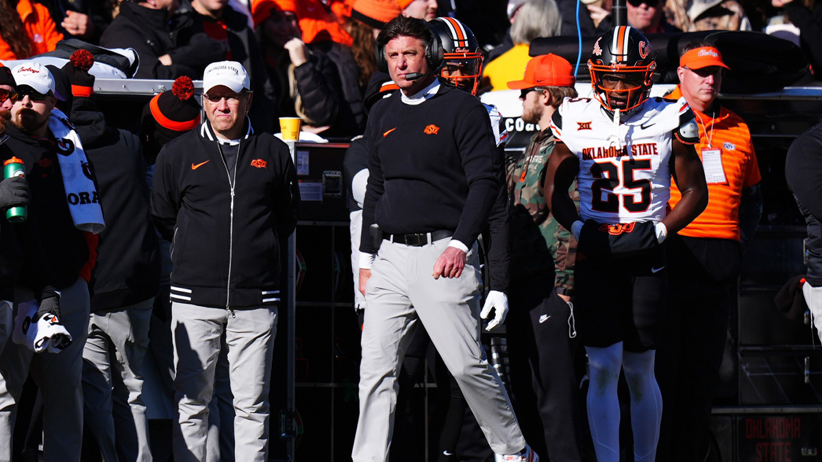 Oklahoma State Cowboys head coach Mike Gundy walks the sidelines the second quarter against the Colorado Buffaloes at Folsom Field.