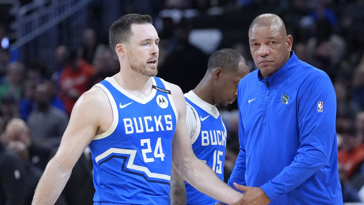Milwaukee Bucks coach Doc Rivers congratulates Milwaukee Bucks guard Pat Connaughton (24) has he comes off the court during a time out against he Detroit Pistons at Fiserv Forum