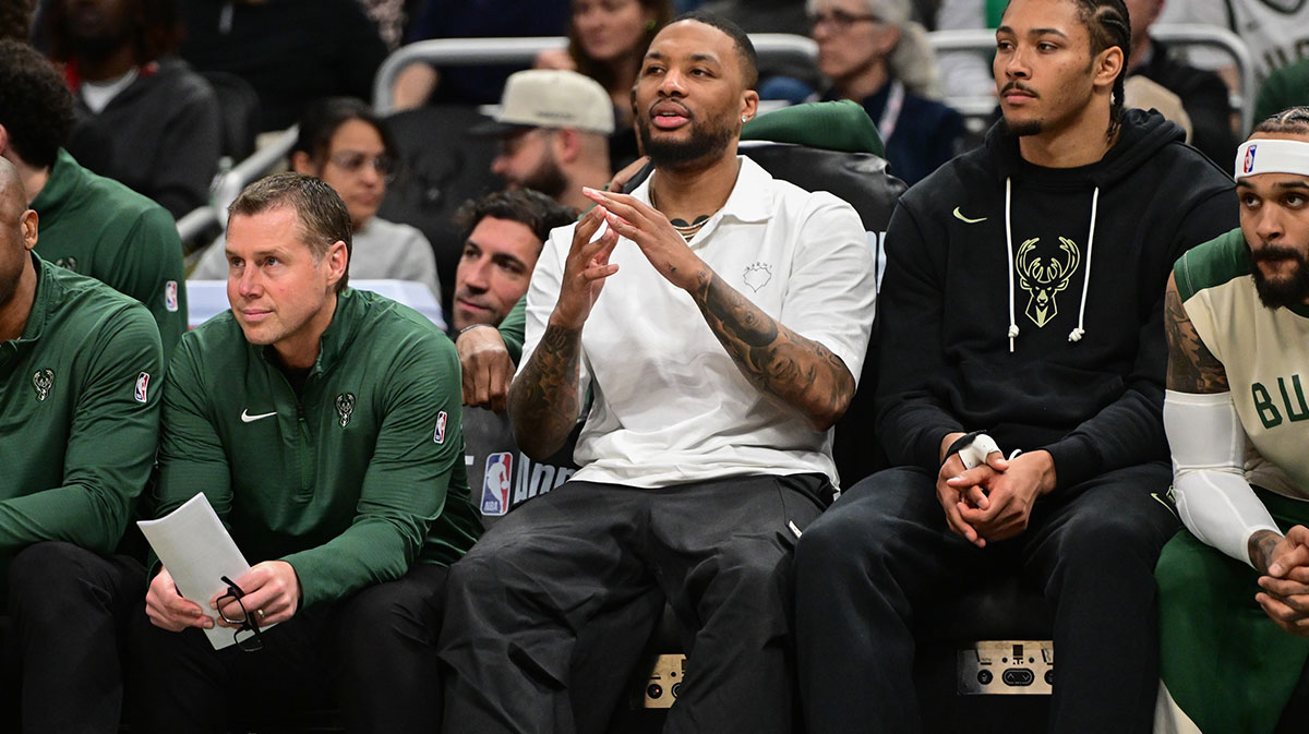 Milwaukee Bucks guard Damian Lillard (center) looks on from the bench while sidelined with an injury in the third quarter against the Phoenix Suns at Fiserv Forum.