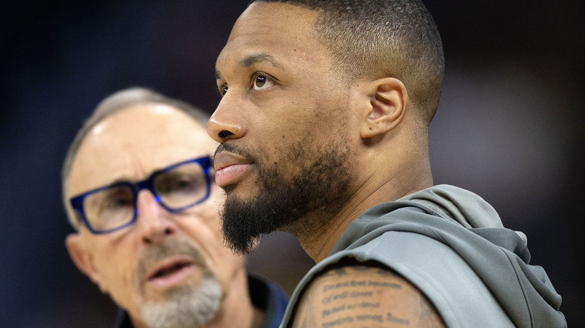 Milwaukee Bucks guard Damian Lillard (right) chats up Golden State Warriors assistant coach Ron Adams before a game at Chase Center.