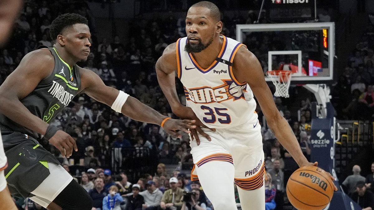 Phoenix Suns forward Kevin Durant (35) brings the ball up as Minnesota Timberwolves guard Anthony Edwards (5) defends him in the fourth quarter at Target Center.