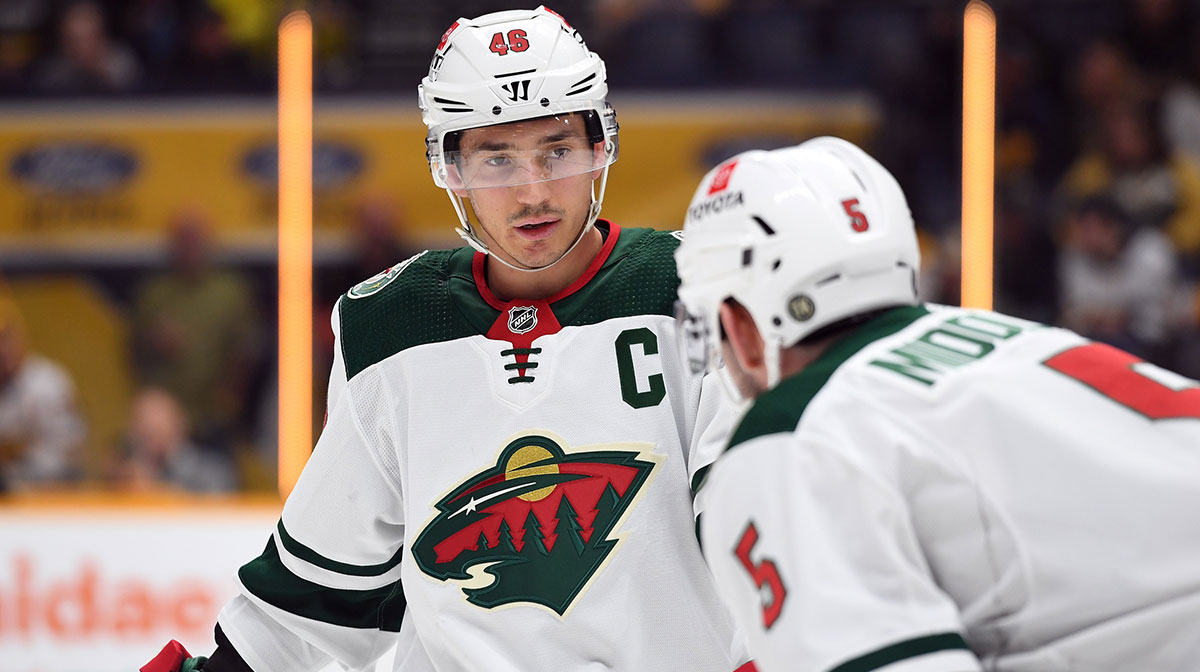 Minnesota Wild defenseman Jared Spurgeon (46) talks with Minnesota Wild defenseman Jacob Middleton (5) before a face off during the first period against the Nashville Predators at Bridgestone Arena.