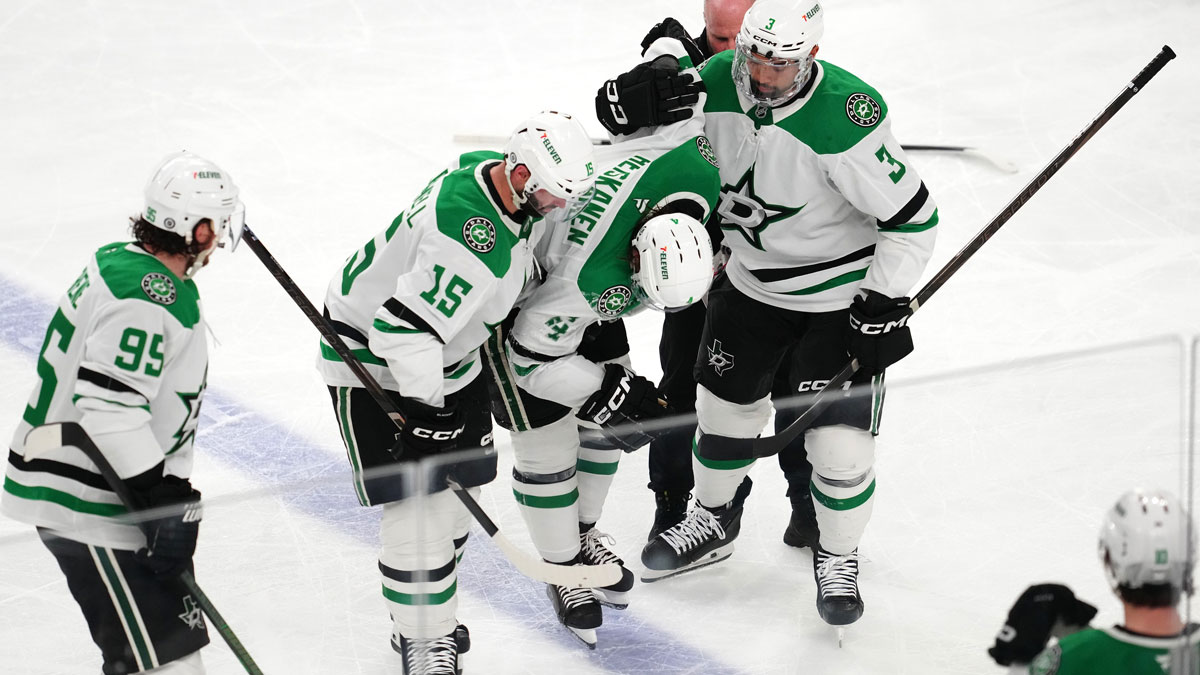 Dallas Stars defenseman Miro Heiskanen (4) is helped off the ice by center Colin Blackwell (15) and defenseman Mathew Dumba (3) after sustaining an injury from a trip by Vegas Golden Knights right wing Mark Stone (not pictured) during the third period at T-Mobile Arena.
