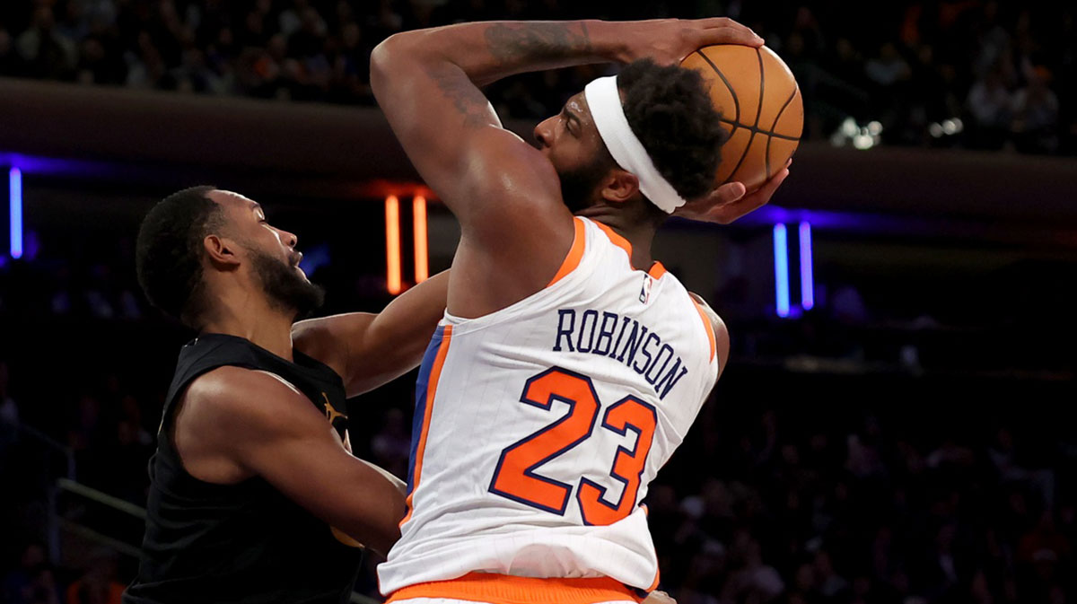 New York Knicks center Mitchell Robinson (23) is fouled by Cleveland Cavaliers forward Evan Mobley (4) as he drives to the basket during the fourth quarter at Madison Square Garden.
