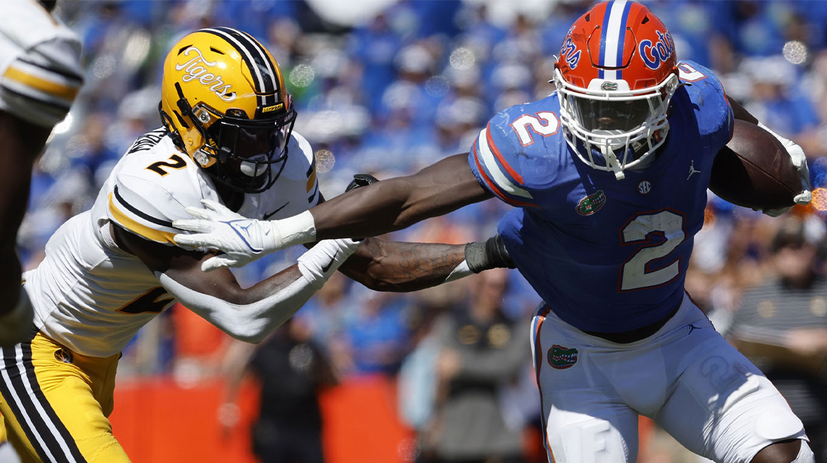 Florida Gators running back Montrell Johnson Jr. (2) runs with the ball as Missouri Tigers defensive back Ennis Rakestraw Jr. (2) defends during the second half at Ben Hill Griffin Stadium.