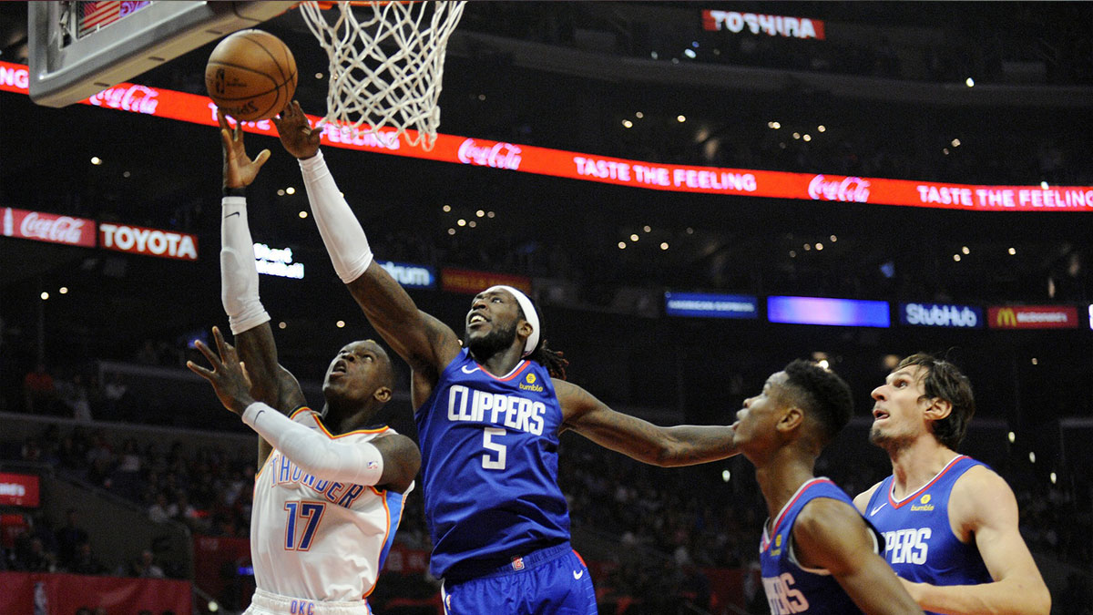 Los Angeles Clippers forward Montrezl Harrell (5) defends against Oklahoma City Thunder guard Dennis Schroder (17) during the first half at Staples Center.